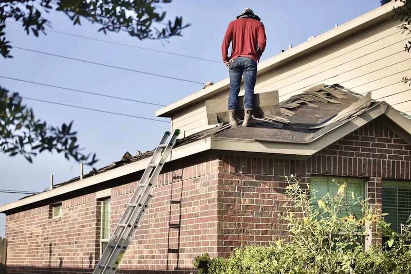Professional roofer working on a residential roof in Pontiac